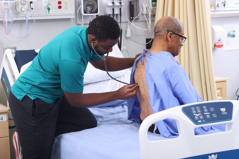 Auscultation left lower lobe, sitting end of bed